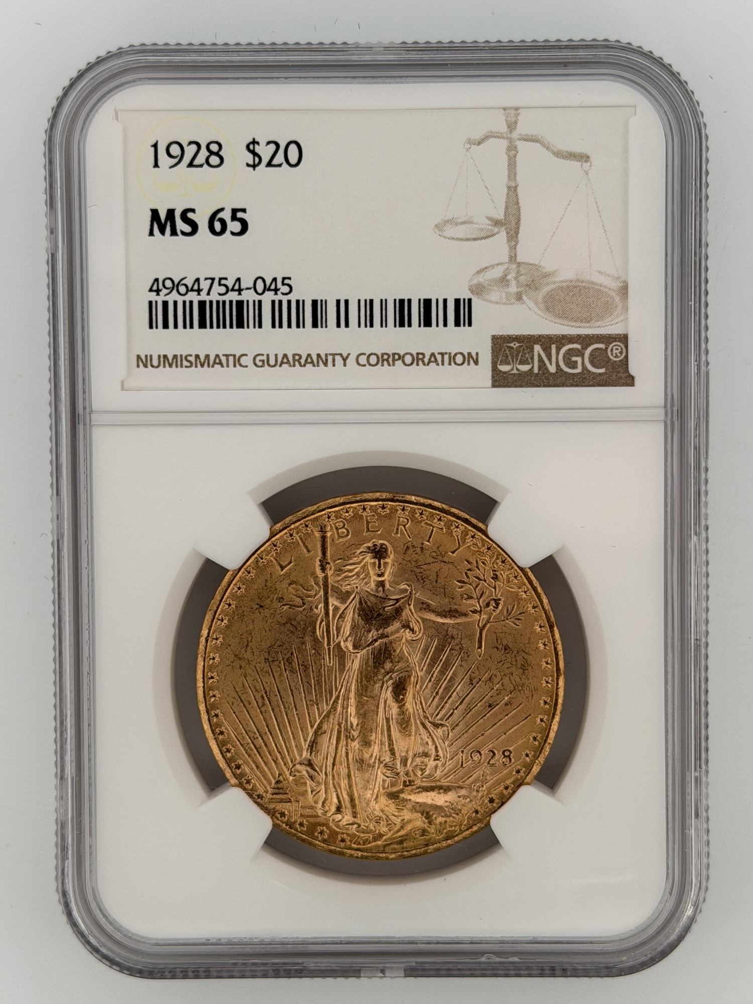 1928 Saint-Gaudens Double Eagle $20 Gold NGC MS65 obverse showing Liberty with torch and olive branch in NGC slab